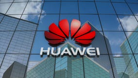 Editorial, Huawei Technologies Co., Ltd. logo on glass building.