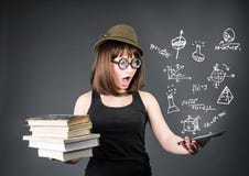 Education school technology concept. Surprised nerd student with old books in one hand and e-reader in another on grey backgro royalty free stock images Education school technology concept. Surprised nerd student with old books in one hand and e-reader in another on grey backgro royalty free stock images