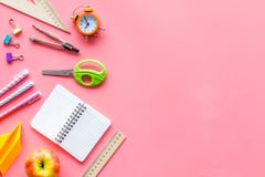 Back To School With Stationary Notebook And Alarm Clock On Pink