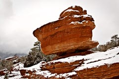 Een rode kei is evenwichtig op een berg in een sneeuw de winterscène royalty-vrije stock afbeelding Een rode kei is evenwichtig op een berg in een sneeuw de winterscène royalty-vrije stock afbeelding
