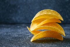 Een stapel knapperige spaanders op een grijze donkere lijst snack royalty-vrije stock foto Een stapel knapperige spaanders op een grijze donkere lijst snack royalty-vrije stock foto