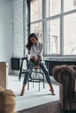 Effortless beauty. Attractive young woman in casual wear resting stock photo Effortless beauty. Attractive young woman in casual wear resting stock photo