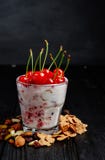 Eigengemaakte yoghurt met vlokken, noten en bessen van frambozen en kersenlepel voor het eten in glas stock afbeeldingen Eigengemaakte yoghurt met vlokken, noten en bessen van frambozen en kersenlepel voor het eten in glas stock afbeeldingen
