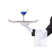 Ein Butler, der ein Tellersegment mit Cocktail anhält lizenzfreie stockfotos Ein Butler, der ein Tellersegment mit Cocktail anhält lizenzfreie stockfotos