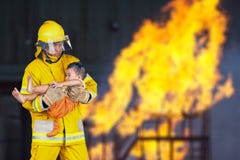 El bombero rescató al niño del fuego imagen de archivo libre de regalías El bombero rescató al niño del fuego imagen de archivo libre de regalías