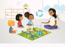 El maestro de jardín de infancia y los niños femeninos sonrientes se sientan en piso y exploran el modelo del juguete con energía ilustración del vector El maestro de jardín de infancia y los niños femeninos sonrientes se sientan en piso y exploran el modelo del juguete con energía ilustración del vector