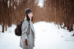 El retrato de una muchacha hermosa feliz con el pelo marrón en el bosque del invierno se vistió en un estilo del inconformista, f imágenes de archivo libres de regalías El retrato de una muchacha hermosa feliz con el pelo marrón en el bosque del invierno se vistió en un estilo del inconformista, f imágenes de archivo libres de regalías