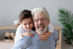 El retrato del nieto feliz tiene el abuelo a cuestas sonriente de la diversi?n fotos de archivo libres de regalías El retrato del nieto feliz tiene el abuelo a cuestas sonriente de la diversi?n fotos de archivo libres de regalías