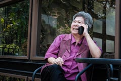 Elder woman talk on mobile phone on terrace. elderly female spea stock image Elder woman talk on mobile phone on terrace. elderly female spea stock image
