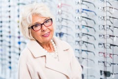 Elder woman trying on glasses stock image Elder woman trying on glasses stock image