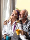 Elderly couple beside windows royalty free stock image Elderly couple beside windows royalty free stock image