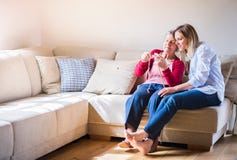 Elderly grandmother and adult granddaughter at home, knitting. Royalty Free Stock Photos Elderly grandmother and adult granddaughter at home, knitting. Royalty Free Stock Photos