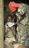 Elderly Ugandan woman cares for grandchild stock photos Elderly Ugandan woman cares for grandchild stock photos