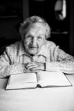 Elderly woman pensioner sitting with a book Royalty Free Stock Images Elderly woman pensioner sitting with a book Royalty Free Stock Images
