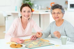 Elderly woman playing board game stock images Elderly woman playing board game stock images