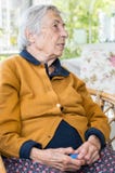 Elderly woman sitting in the balcony having conversation with her family. Royalty Free Stock Photos Elderly woman sitting in the balcony having conversation with her family. Royalty Free Stock Photos