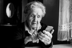 Elderly woman typing on the smartphone. Education. royalty free stock photo Elderly woman typing on the smartphone. Education. royalty free stock photo
