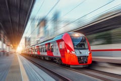 Electric Passenger Train Drives At High Speed Among Urban Landscape Royalty Free Stock Photo