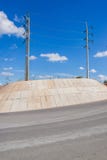 Electric pole on a hill next to the road at a curve. Stock Images Electric pole on a hill next to the road at a curve. Stock Images