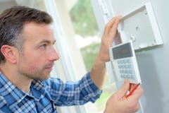 Electrician fitting intrusion alarm stock photos Electrician fitting intrusion alarm stock photos
