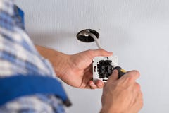 Electrician hands installing wall socket stock photo Electrician hands installing wall socket stock photo
