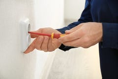 Electrician installing wall socket in new building, Stock Image Electrician installing wall socket in new building, Stock Image