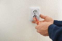 Electrician installing wall socket in new building, Stock Photography Electrician installing wall socket in new building, Stock Photography