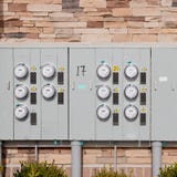 Electricity Meters On A Brick Wall. Stock Photo Electricity Meters On A Brick Wall. Stock Photo
