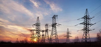Electricity Pylons And Lines At Dusk. Royalty Free Stock Images