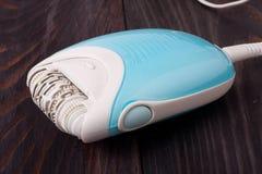 Electro depilator on wooden table. stock photos Electro depilator on wooden table. stock photos