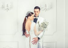 Elegant bride and groom embracing sensually stock image Elegant bride and groom embracing sensually stock image