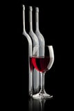 Elegant red wine glass and a wine bottles