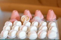 Elegant sweet table with big cake, cupcakes, cake pops on dinner or event party. Tray with delicious cakes and macaroon. Catering stock photography Elegant sweet table with big cake, cupcakes, cake pops on dinner or event party. Tray with delicious cakes and macaroon. Catering stock photography