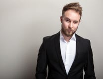 Elegant young handsome bearded man in classic black costume & white shirt. Royalty Free Stock Image Elegant young handsome bearded man in classic black costume & white shirt. Royalty Free Stock Image