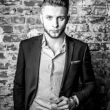 Elegant young handsome men pose against old brick wall. royalty free stock image Elegant young handsome men pose against old brick wall. royalty free stock image