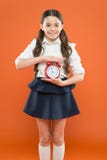 Elementary school day bell schedule. Schooltime concept. Schoolgirl child formal uniform hold alarm clock. Time to study royalty free stock photos Elementary school day bell schedule. Schooltime concept. Schoolgirl child formal uniform hold alarm clock. Time to study royalty free stock photos
