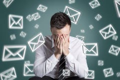 Email symbols swirling around an overstrained man stock photo Email symbols swirling around an overstrained man stock photo