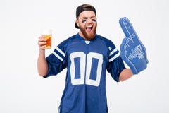 Emotional man fan in blue t-shirt drinking beer. royalty free stock photos Emotional man fan in blue t-shirt drinking beer. royalty free stock photos