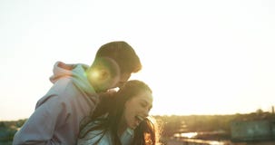 Emotional portrait of the happy beautiful young couple tenderly hugging. The handsome guy is tickling his charming lover stock video Emotional portrait of the happy beautiful young couple tenderly hugging. The handsome guy is tickling his charming lover stock video