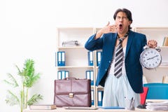 The employee coming to work straight from bed stock images The employee coming to work straight from bed stock images