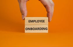 Employee onboarding success symbol. Wooden blocks with words `Employee onboarding` on beautiful orange background. Businessman