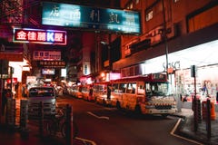 Empty buses resting under signboards in the evening on a street of Hong Kong stock image Empty buses resting under signboards in the evening on a street of Hong Kong stock image