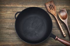 Empty Clean Cast Iron Frying Pan On Wooden Background stock photos Empty Clean Cast Iron Frying Pan On Wooden Background stock photos