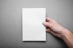 Empty Mock-up Blank catalog, magazine, book template in man hand with soft shadows on grey background for design stock images Empty Mock-up Blank catalog, magazine, book template in man hand with soft shadows on grey background for design stock images