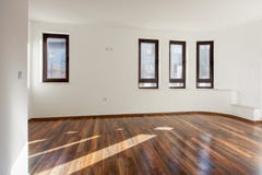 Empty room with natural light from windows.Modern house interior. White walls. Wooden floor. Stock Image Empty room with natural light from windows.Modern house interior. White walls. Wooden floor. Stock Image