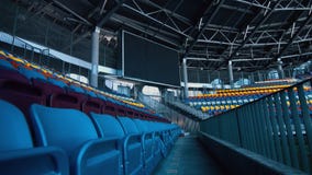 Empty sports stadium with nobody from tribune and big scoreboard