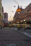 Empty square with evening illumination and occasional passers stock photo Empty square with evening illumination and occasional passers stock photo