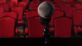 On an empty stage microphone in front of an empty hall. Scene. Microphone on stage close-up