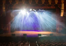 An empty stage of the theater, lit by spotlights and smoke stock image An empty stage of the theater, lit by spotlights and smoke stock image