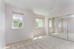 Empty sun filled bedroom with carpet floor. stock photos Empty sun filled bedroom with carpet floor. stock photos